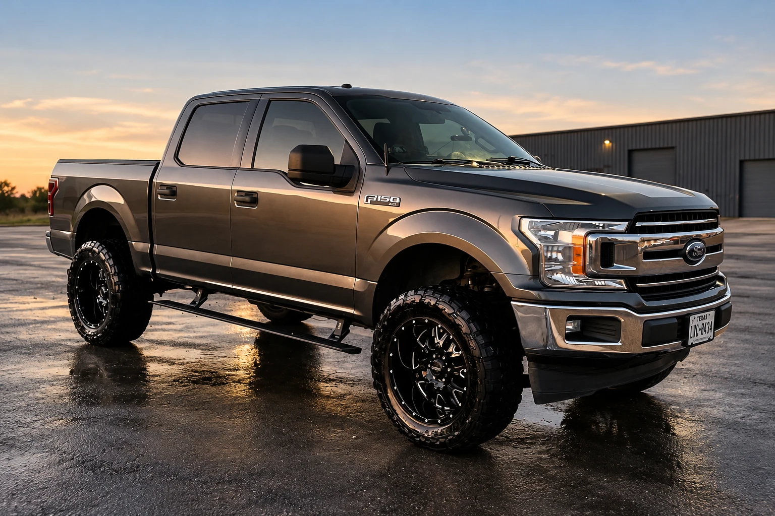 Gray Ford F-150 with chrome grille and black wheels at dusk